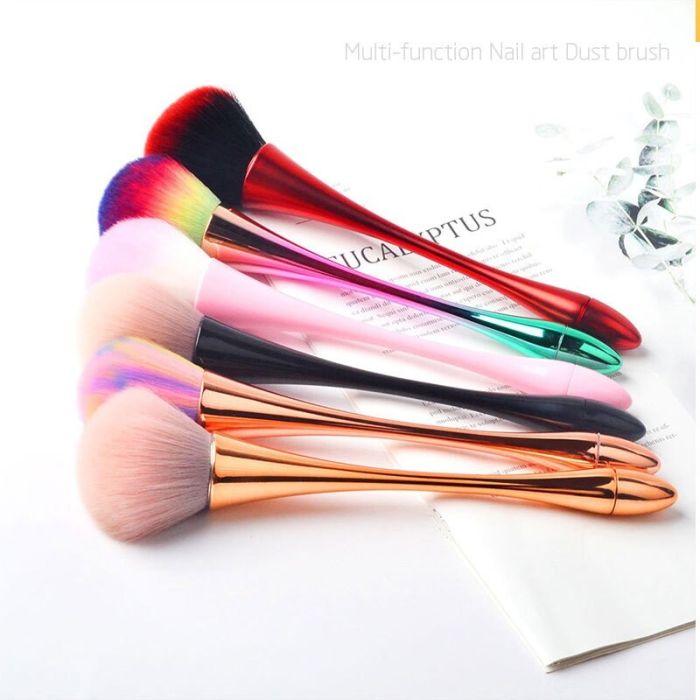 A makeup brush for powder and blush in a gift box with a rainbow bow